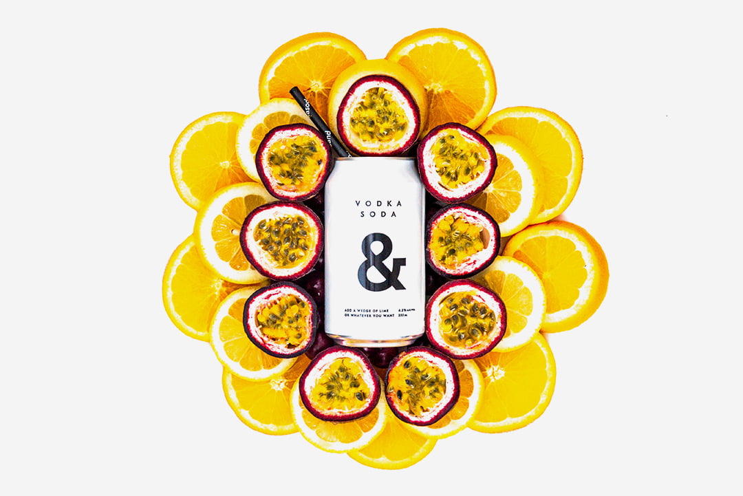 Vodka soda can drink on top of cut oranges